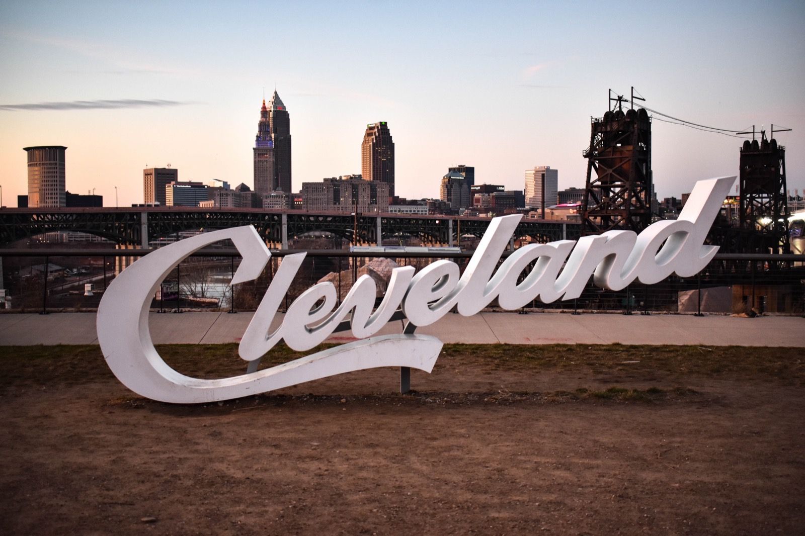Cleveland script sign overlooking the downtown skyline at dusk